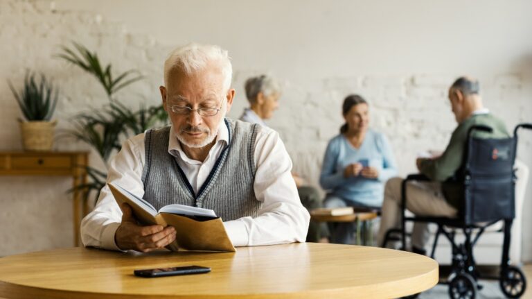 senior reading in a nursing home