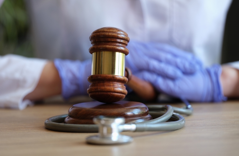 wooden judge gavel on doctor's table