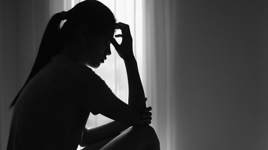 Sad woman sitting in dark room