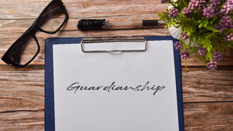 eyeglasses and pen with Guardianship paper