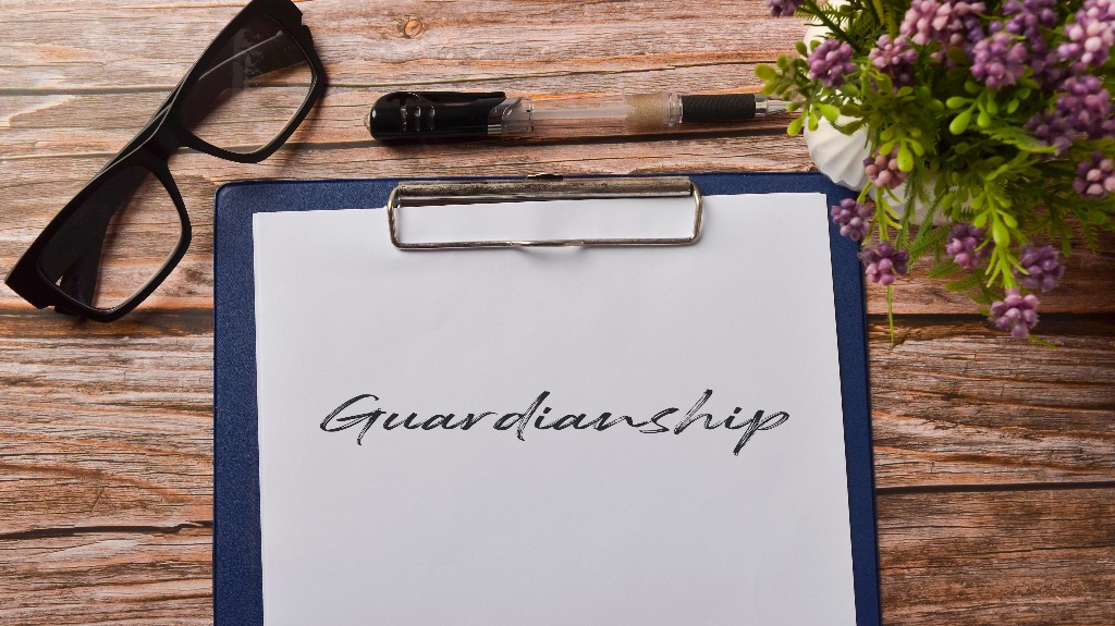 eyeglasses and pen with Guardianship paper