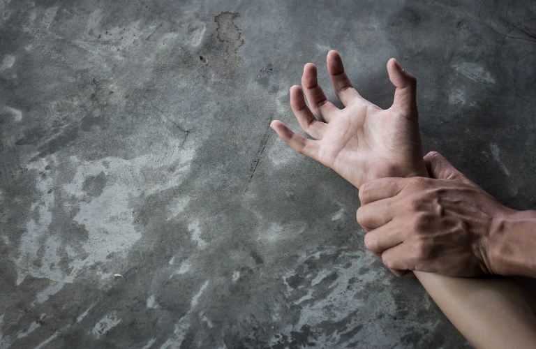 man's hand holding a woman hand